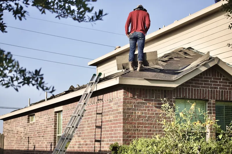 Professional roofer working on a residential roof in Dixie Belle